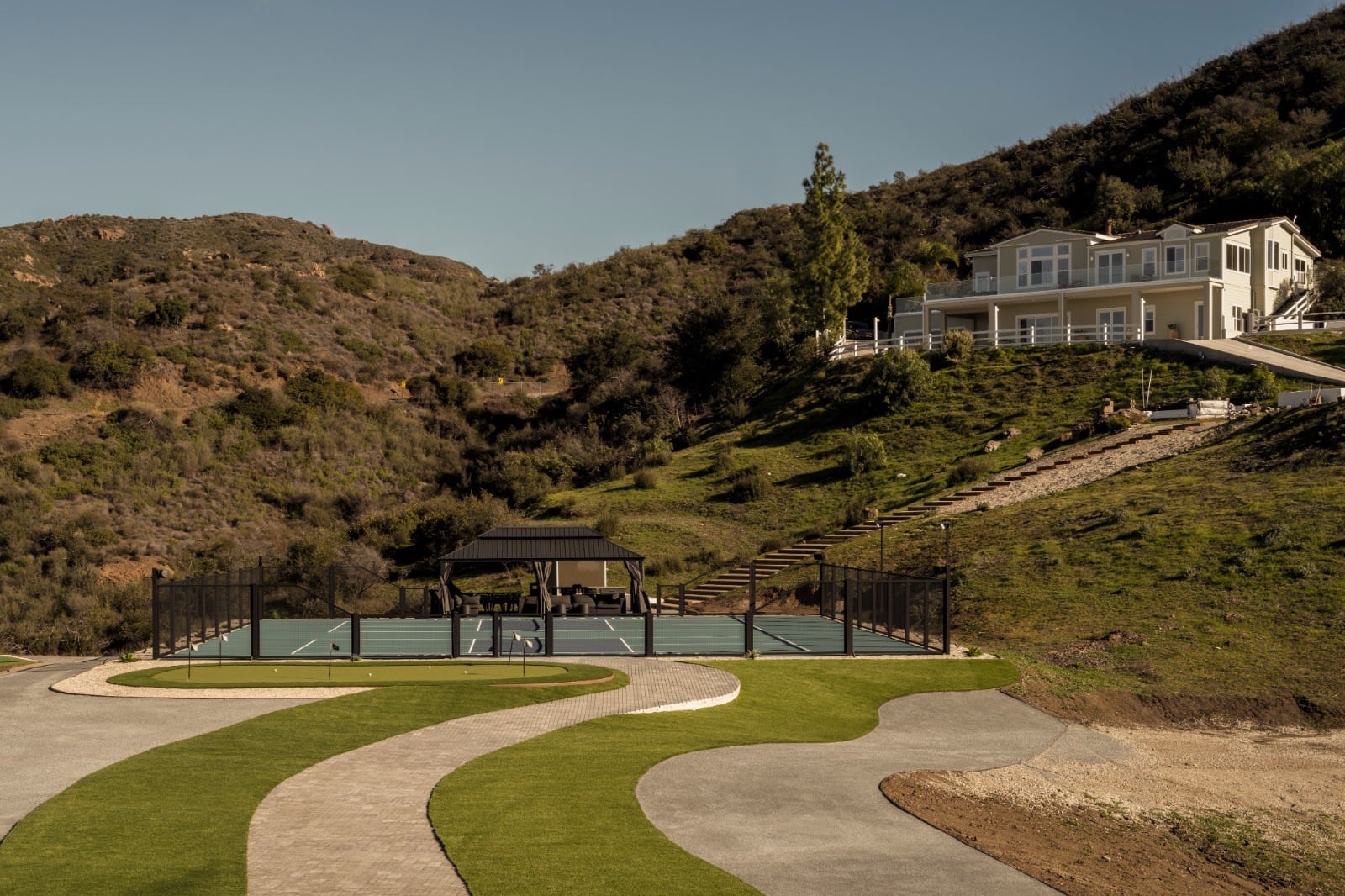 Modern hillside estate approached by a curving drive through a Los Angeles canyon