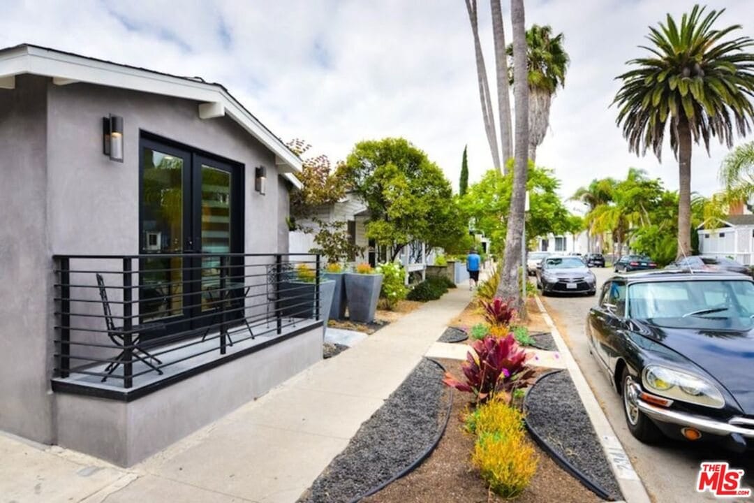 The Beach Avenue triplex from the street, with palms running down the block in Venice