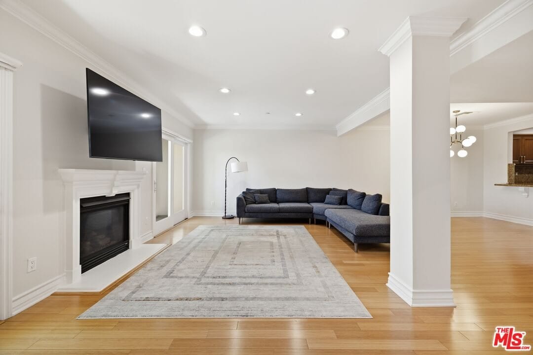 Living room with the fireplace and a sectional sofa at 1838 Westholme Avenue, Westwood